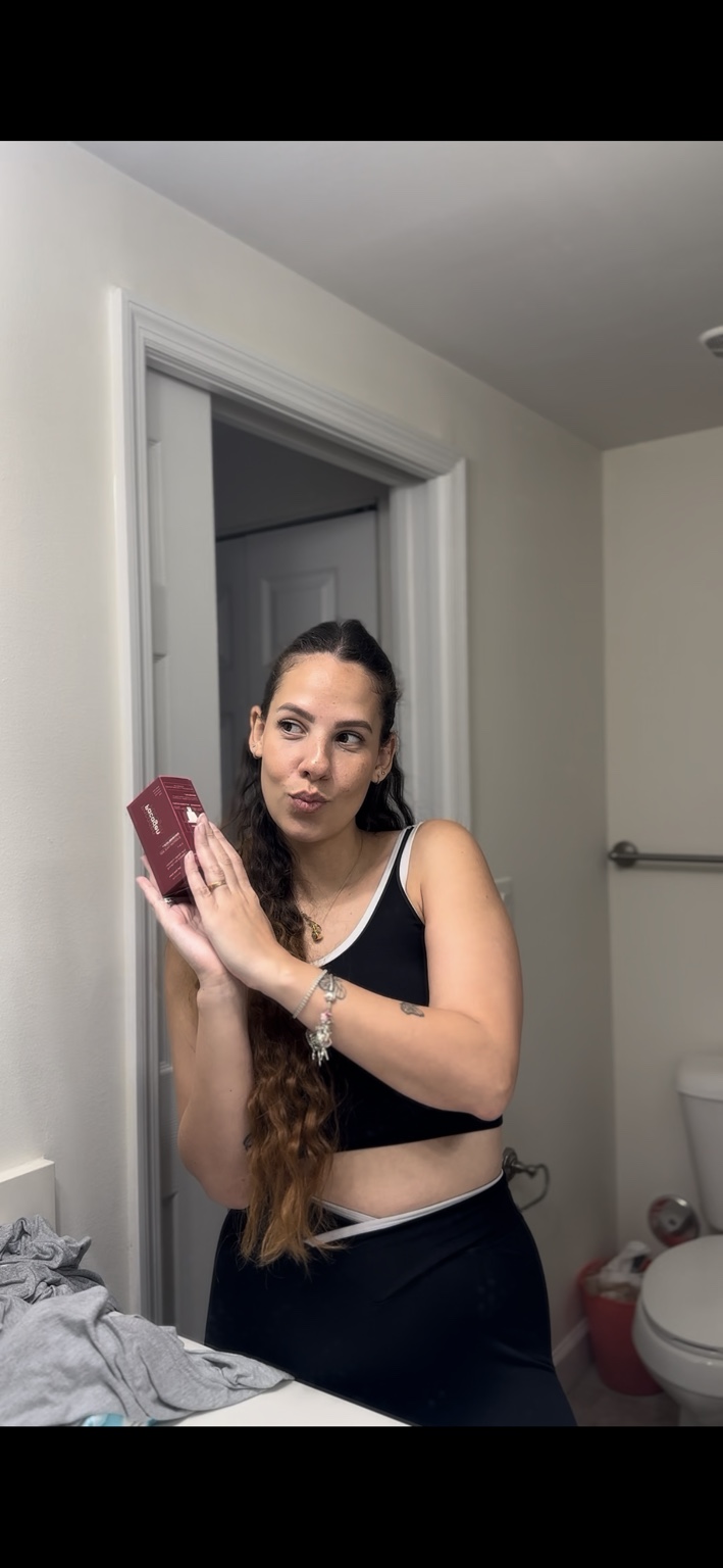 Beatriz holding a Pacagen skincare product
