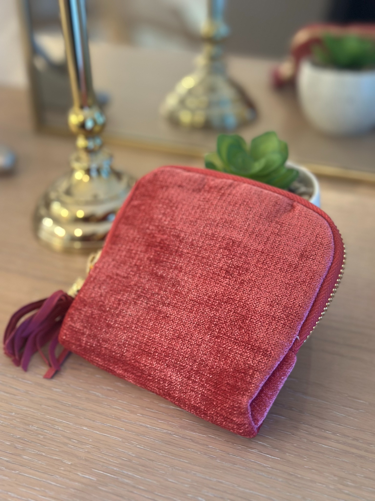 Pink jewelry organizer photographed on a wooden surface